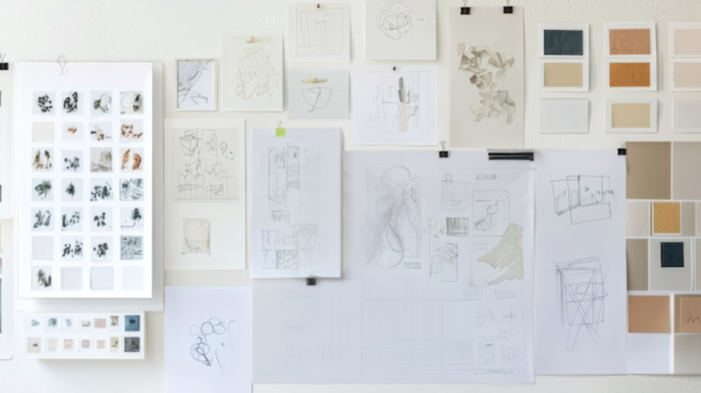 Brand design moodboard wall with sketches, color swatches, and material samples